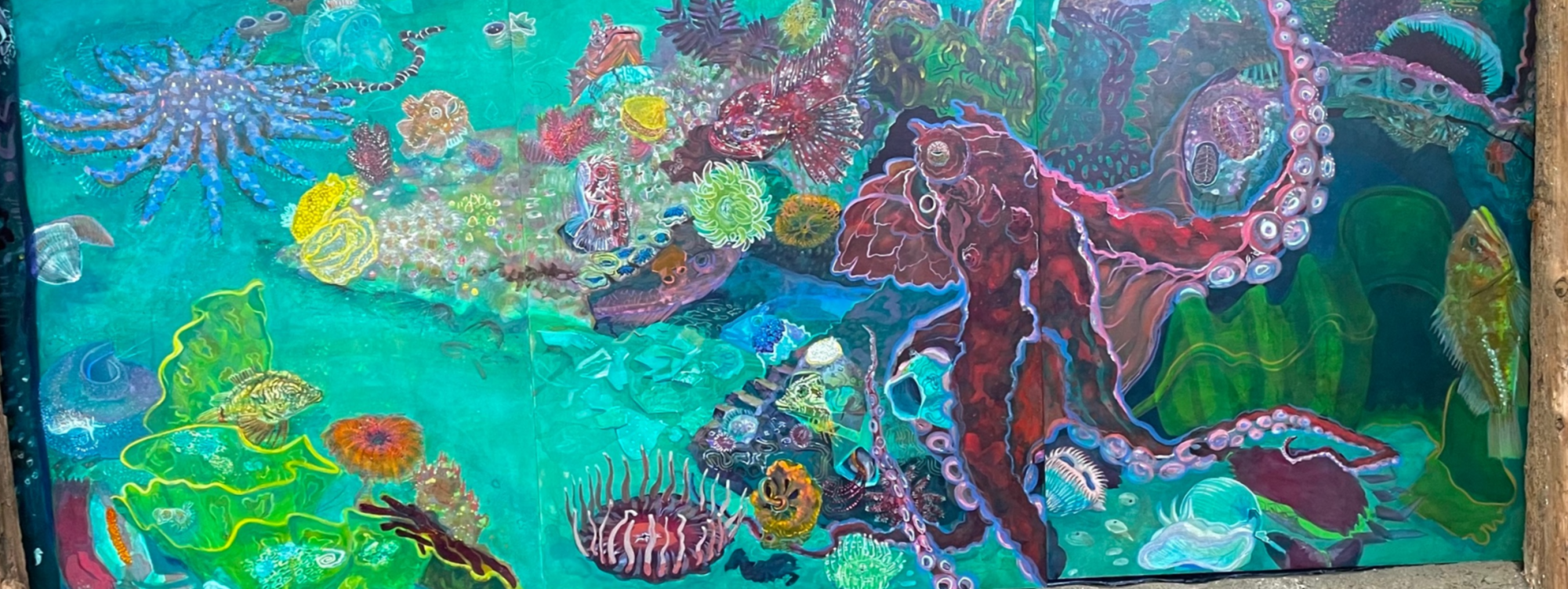 Colorful undersea mural in deep sea greens and blues featuring an octopus and other sea life from the pacific northwest.